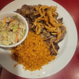 Steak dinner.  10 Oz rib eye with Spanish rice and cauliflower slaw.