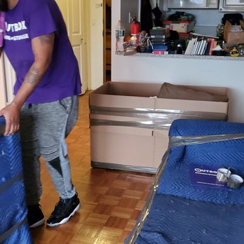 Outbox Moving & Storage - Foreman preparing items for the move, blanketing large/upholstered items. - Movers Near Me - Brooklyn, New York Outbox Moving & Storage - Foreman preparing items for the move, blanketing large/upholstered items. - Movers Near Me - Brooklyn, New York