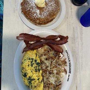 Lincoln Square Pancake House - Spinach and cheddar filled omelet, thick sliced bacon, hash browns, 3 thick and fluffy pancakes. - Breakfast & Brunch Near Me - Indianapolis, Indiana Lincoln Square Pancake House - Spinach and cheddar filled omelet, thick sliced bacon, hash browns, 3 thick and fluffy pancakes. - Breakfast & Brunch Near Me - Indianapolis, Indiana