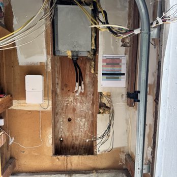Origins-Electric - Old panel removed. Note wires on the right side - Electricians Near Me