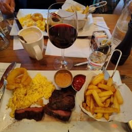 Skirt steak and eggs frites with a ramekin of au poivre sauce and a glass of Australian Shiraz, all good. Skirt steak and eggs frites with a ramekin of au poivre sauce and a glass of Australian Shiraz, all good.
