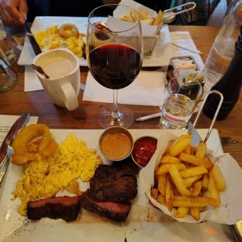 The Ellington - Skirt steak and eggs frites with a ramekin of au poivre sauce and a glass of Australian Shiraz, all good. - American Near Me - New York, New York The Ellington - Skirt steak and eggs frites with a ramekin of au poivre sauce and a glass of Australian Shiraz, all good. - American Near Me - New York, New York
