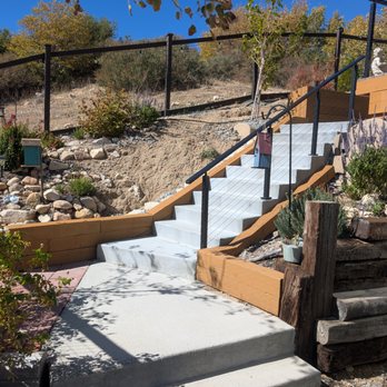Joe Queen Construction - Third remodel - New stairs and custom wood siding along stairs. - General Contractors Near Me