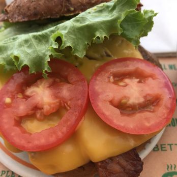 Next Level Burger - Close-up of sausage bacon burger with cheddar cheese - Burgers Near Me - Concord, California Next Level Burger - Close-up of sausage bacon burger with cheddar cheese - Burgers Near Me - Concord, California