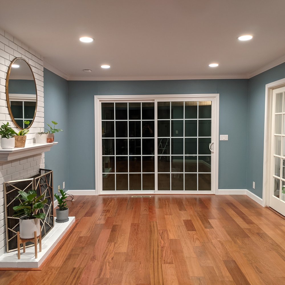 EHR - Family room - after. Added molding, painted fireplace, replaced carpet with hardwood, painted walls and ceiling. - Flooring Near Me