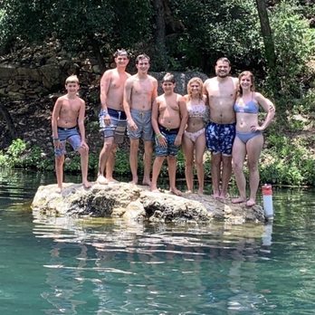 Heidelberg Lodges - Family Photo on Lodge river rock - Hotels Near Me - New Braunfels, Texas Heidelberg Lodges - Family Photo on Lodge river rock - Hotels Near Me - New Braunfels, Texas
