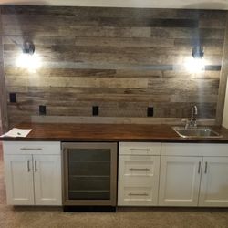On Point Home Solutions - Installed basement counter with a wine fridge and rough cut accent wall