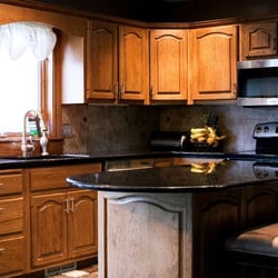 Prestige Tile and Stone - Marron Cohiba granite with custom tile backsplash. Prestige Tile and Stone, LLC