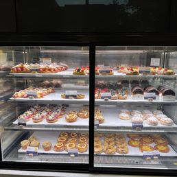 Pastry case with donuts and croissants. Pastry case with donuts and croissants.