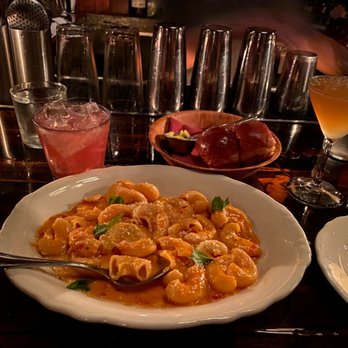 Trivoli Tavern - Vodka rigatoni, Airmail cocktail on the right side, and basket of Hawaiian-like bread rolls - American Near Me - Chicago, Illinois Trivoli Tavern - Vodka rigatoni, Airmail cocktail on the right side, and basket of Hawaiian-like bread rolls - American Near Me - Chicago, Illinois