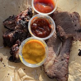 Burnt ends on the left. Brisket on the right. Complete with sauces! Burnt ends on the left. Brisket on the right. Complete with sauces!
