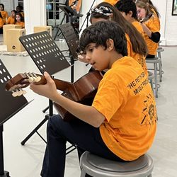 The Norwalk Art Space - Students part of the Petty-Drayton Beginner Guitar performing at the fall semester Student Concert