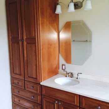 Custom Cherry Cabinetry Vanity And Linen Pantry With Crema Marfil