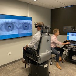 Colorado Ear Care - Cory Tickle, audiologist at Colorado Ear Care, performs a balance disorder test using a rotary chair