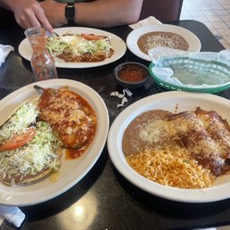 Enchiladas Tapatias and side order of Refried Beans on the far side House Dinner two plates closest Enchiladas Tapatias and side order of Refried Beans on the far side House Dinner two plates closest