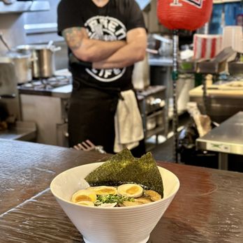Yugiri Ramen Project - Spicy Miso, with an extra egg and the owner Mike  in the background. - Ramen Near Me - Sanford, Florida