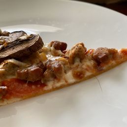 a slice of pizza on a plate a slice of pizza on a plate