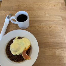 Fish cake over beans and americano. Fish cake over beans and americano.