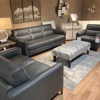 Peerless Furniture - Leather group with accent ottoman and rug. - Furniture Stores Near Me - Fairview Heights, Illinois