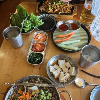 Tiger Mama - From the top going clockwise: Jaeyook, veggies, tofu, Japchae, banchan and sesame leaves to wrap the Jaeyook in. - Korean Near Me - Eugene, Oregon Tiger Mama - From the top going clockwise: Jaeyook, veggies, tofu, Japchae, banchan and sesame leaves to wrap the Jaeyook in. - Korean Near Me - Eugene, Oregon