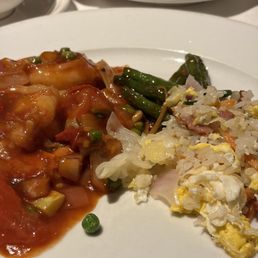 Spicy shrimp plated with house fried rice and string beans