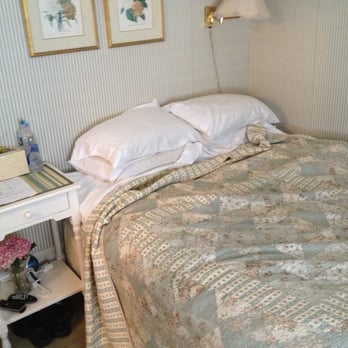 Prince Albert Guest House - Room 15 bed and bed table. - Guest Houses Near Me - Provincetown, Massachusetts