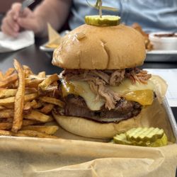 Rodeo burger with grilled onion, 2 kinds of cheese, brisket, and pulled pork.