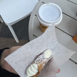 a person holding a pastry a person holding a pastry
