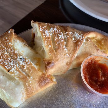 Sal's Gilbert Pizza - Half eaten Stromboli, just couldn't wait to dig in! - Pizza Near Me - Gilbert, Arizona