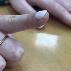 Rainbow Nail & Spa - Dip powder on finger.