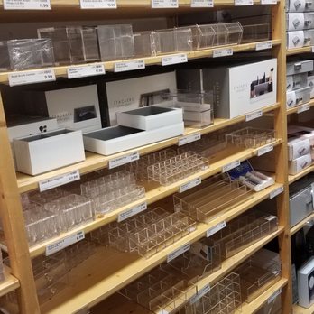 The Container Store - Clear plastic storage containers of various sizes are displayed on wooden shelves in a retail store, with price tags visible. - Home Organization Near Me - Natick, Massachusetts