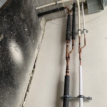 Smart Solutions - two pipes connected to a wall - Flooring Near Me