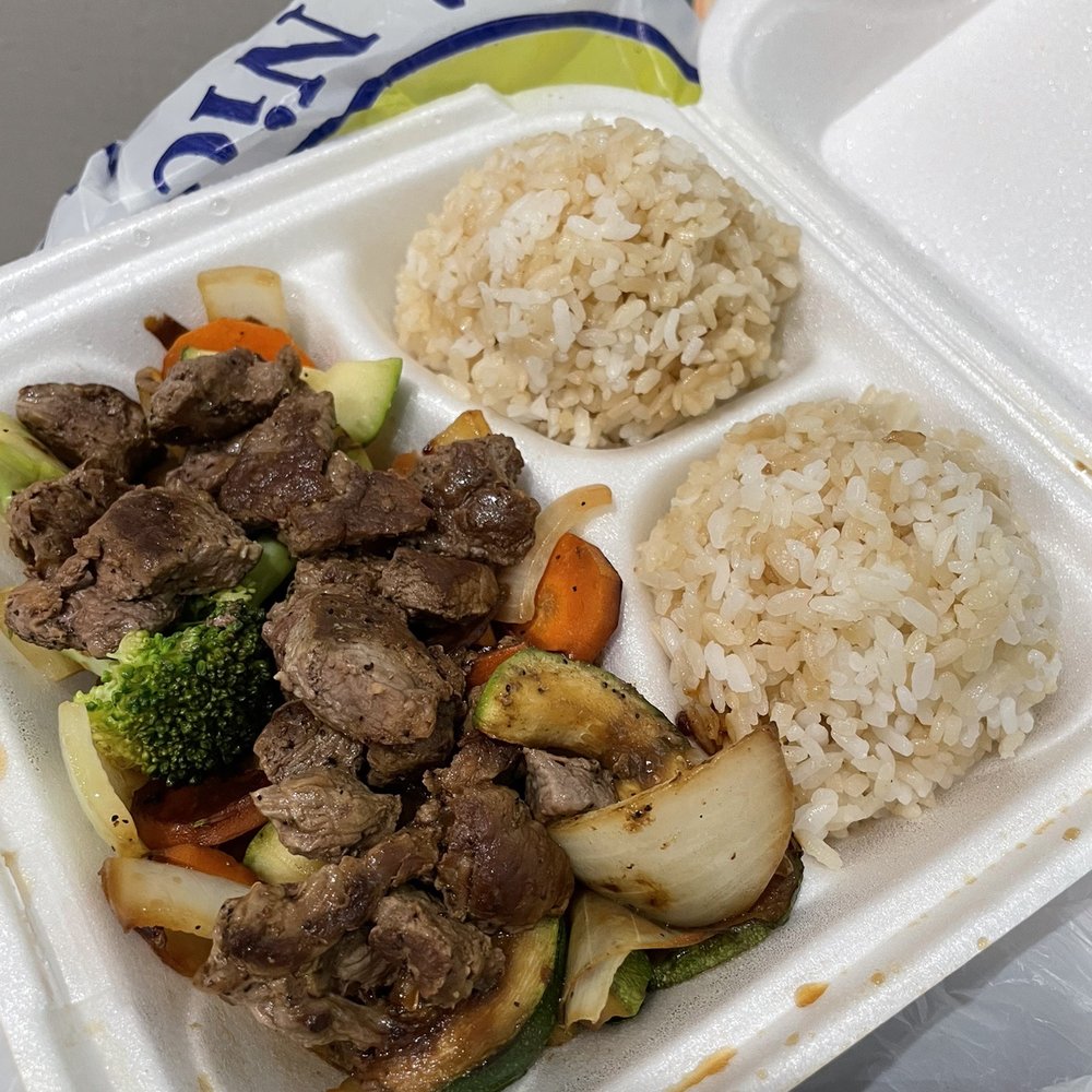 a tray of food with rice and meat a tray of food with rice and meat