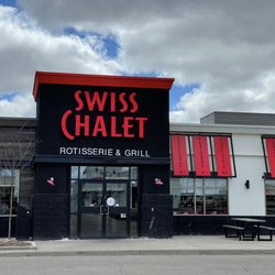 Swiss Chalet Rotisserie & Grill - Store front-Outdoor seating and plenty of parking.
