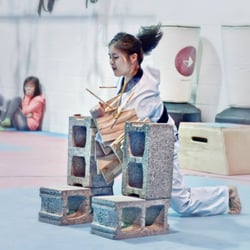 Authentic Taekwondo and Kickboxing - Crystal showing how to break multiple boards with one strike.