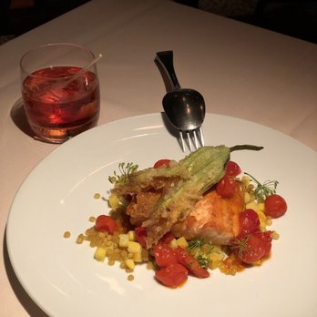 Le Filet - Seared salmon with Israeli couscous topped with friend zucchini flowers - Seafood Near Me - Montreal, Quebec