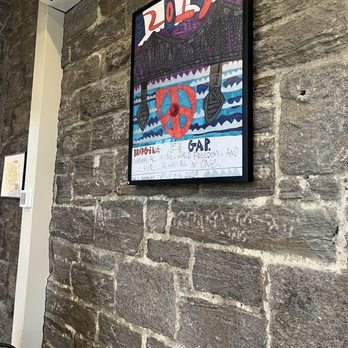 Coffee For Good - a poster on a brick wall - Cafes Near Me - Greenwich, Connecticut