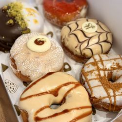 Saint Honoré - pistachio dubai chocolate, crème brûlée banana milk, guava cheesecake, chocolate caramel hazelnut, salted caramel, cookie butter