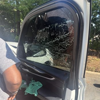 One Degree Mobile Tint - Ian who works for "One Degree Mobile Tint" window tinting company, is putting new tint on my Bmw X5 including a windshield strip. - Car Window Tinting Near Me