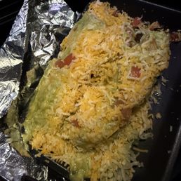 Two flautas, smothered in cheese, guac, and more.
