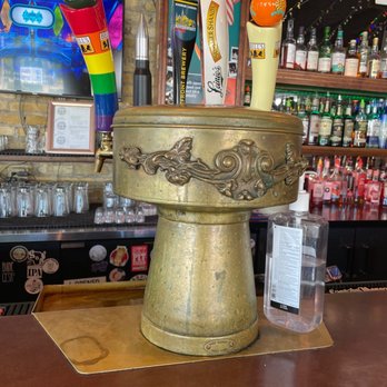 Vintage - a bar with a gold vase with candles on it - Bars Near Me - Milwaukee, Wisconsin