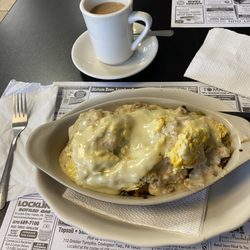 502 Deli and Grill - Biscuits, scrambled eggs, peppers, onions, home fries, American cheese, sausage gravy en casserole, This is a fantastic special ‍