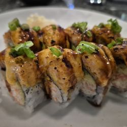 Lovers Roll - Crab meat, avocado, cucumber inside, topped with spicy seared salmon, scallion, spicy mayo, unagi sauce.