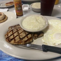 Country Ham N Egg Restaurant - Pork chop with eggs, grits, English muffin.