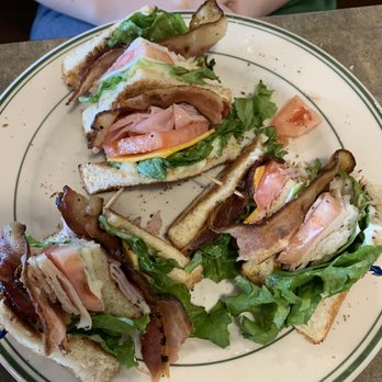 Marlin's Family Restaurant - Club sandwich with one eaten - New American Near Me - Mitchell, South Dakota