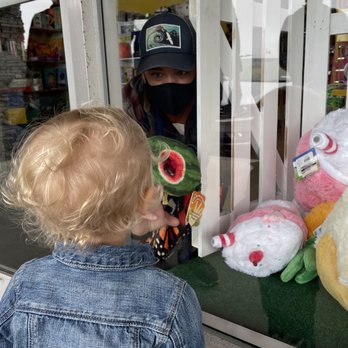 The Magic Toybox - Our daughter checking out the amazing window display of stuffed animals shown off by the staff. - Toy Stores Near Me - Pacifica, California