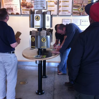 Which Wich - a group of people standing around a table - Sandwiches Near Me - Huntersville, North Carolina Which Wich - a group of people standing around a table - Sandwiches Near Me - Huntersville, North Carolina