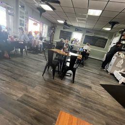 The image shows the interior of Fiddlestix Cafe in Cornwall, NY, with several customers seated at tables and a staff member working near the counter.