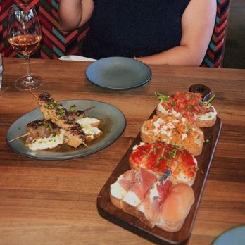 Postino 9CO - Skewers, Bruschetta board with spicy pepper jam and goat cheese, prosciutto and mascarpone, sweet corn, and burrata - Wine Bars Near Me - Denver, Colorado Postino 9CO - Skewers, Bruschetta board with spicy pepper jam and goat cheese, prosciutto and mascarpone, sweet corn, and burrata - Wine Bars Near Me - Denver, Colorado