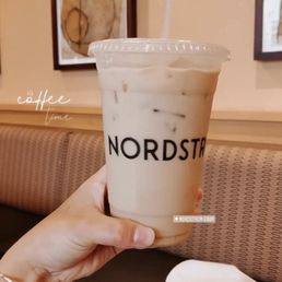 a hand holding a cup of coffee